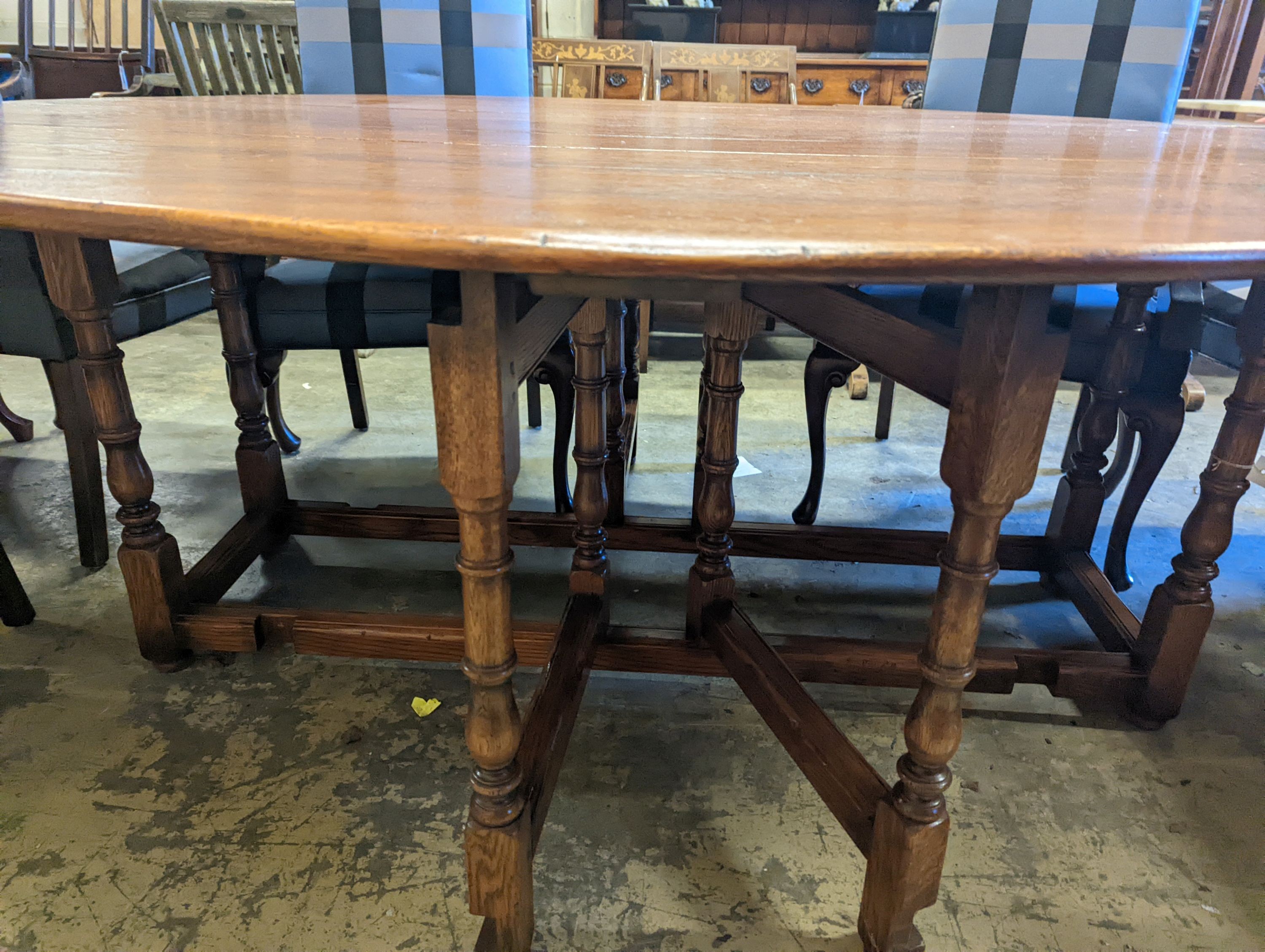 An 18th century style oak gateleg 'wake' dining table, length 200cm, 150cm extended, height 75cm